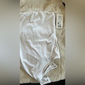 Sleeveless white bodysuit-